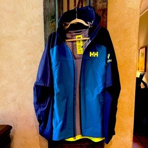 Mens XL Helly Hansen Odin Shell Jacket. New without Tags. Teal color w Navy .
